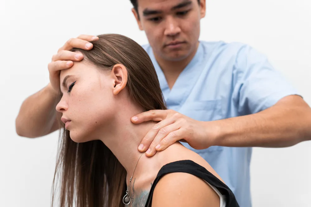 Chiropractor examining patient’s neck for hidden car accident injuries