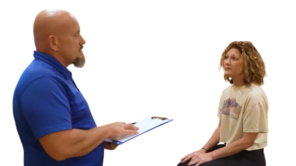 Dr. Micah Carter discussing health goals with female chiropractic patient