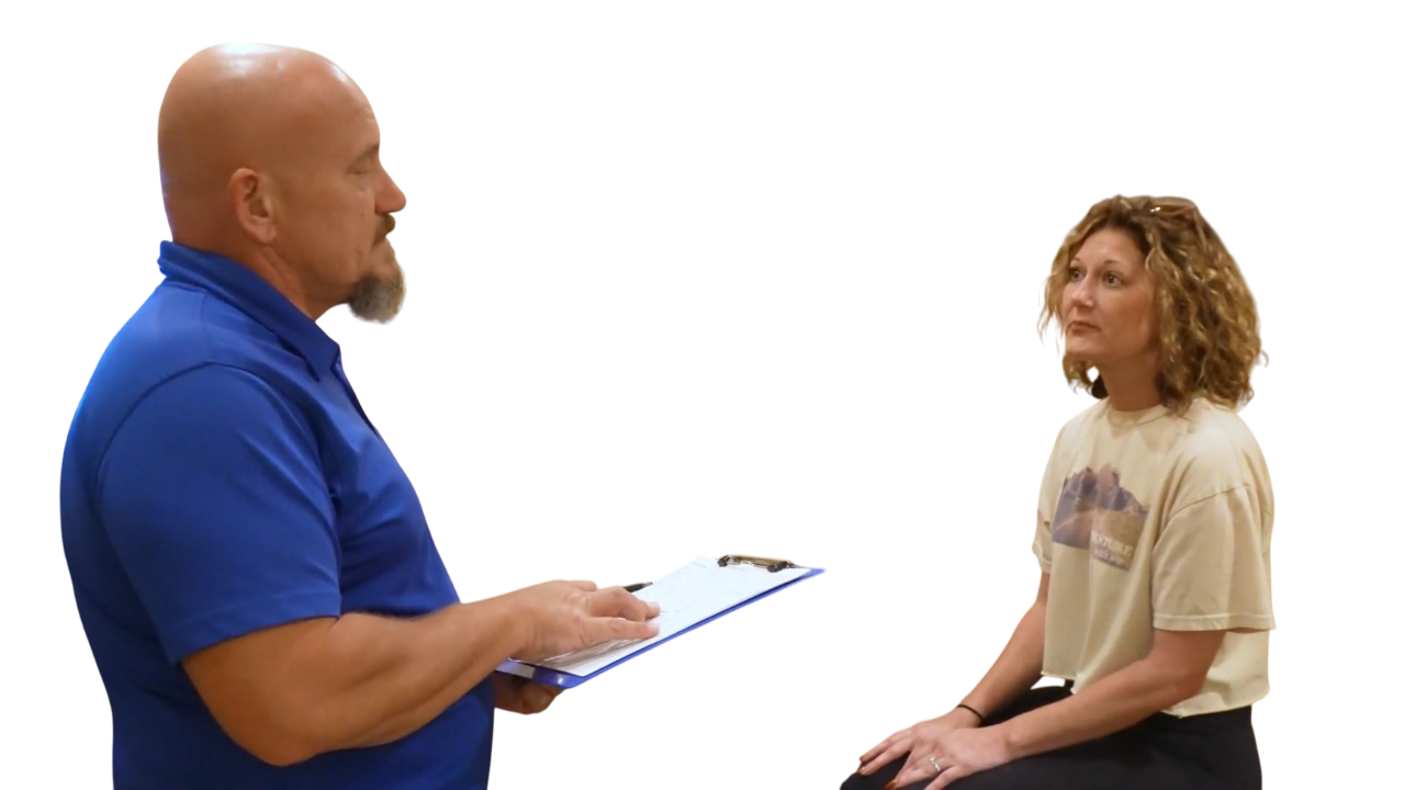 Dr. Micah Carter discussing health goals with female chiropractic patient