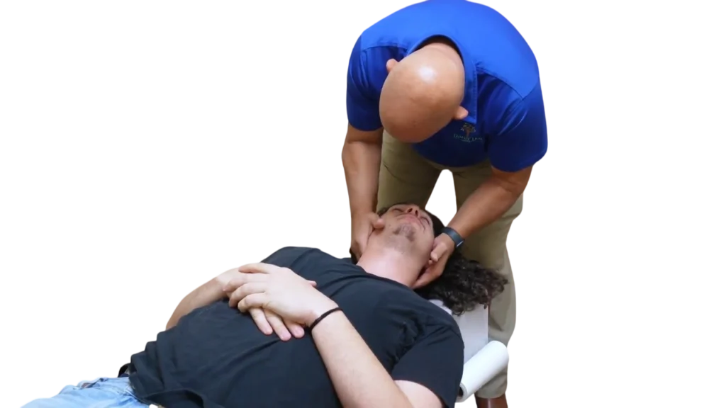 Dr. Micah Carter giving neck adjustment to male patient at Family Tree Chiropractic
