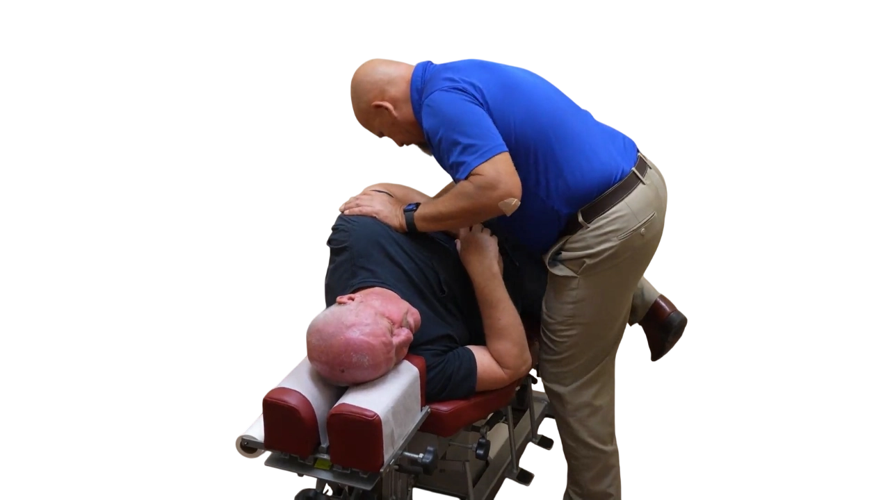 Dr. Micah Carter performing lumbar adjustment on male chiropractic patient
