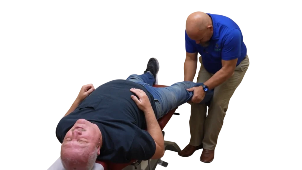 Dr. Micah Carter performing a knee adjustment on a male chiropractic patient