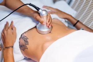Young woman lying straight on table during abdominal rejuvenation procedure