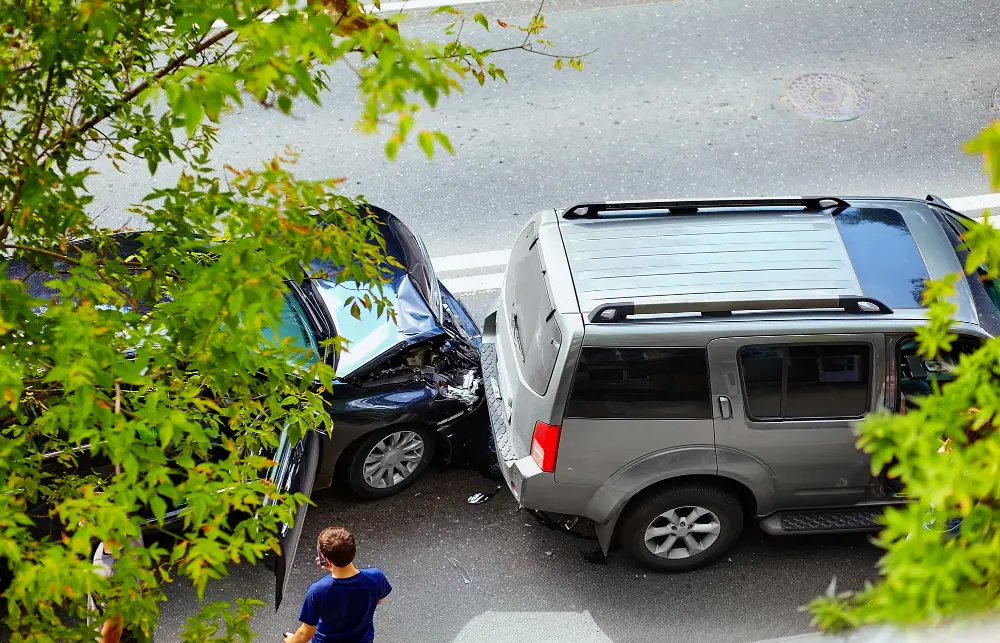 Overhead view of two vehicles involved in a car accident on a city street