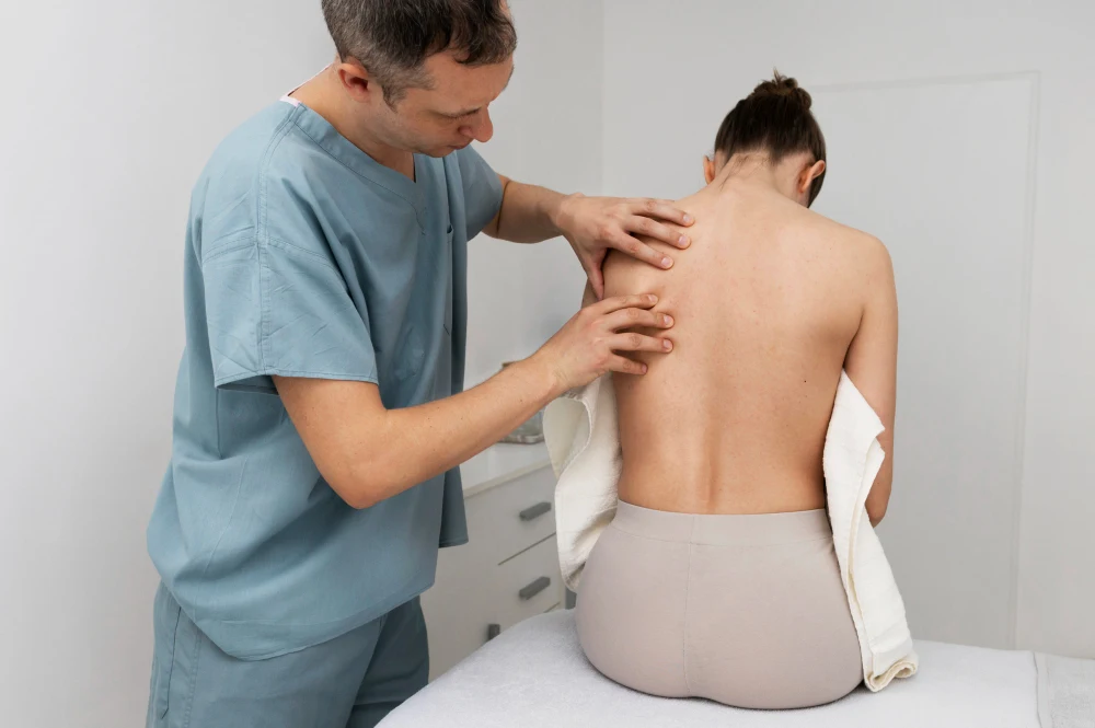 Chiropractor examining woman with failed back surgery syndrome