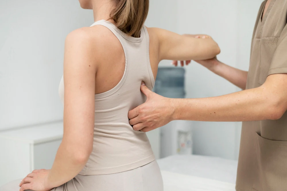Chiropractor assessing woman for posture correction and spinal alignment