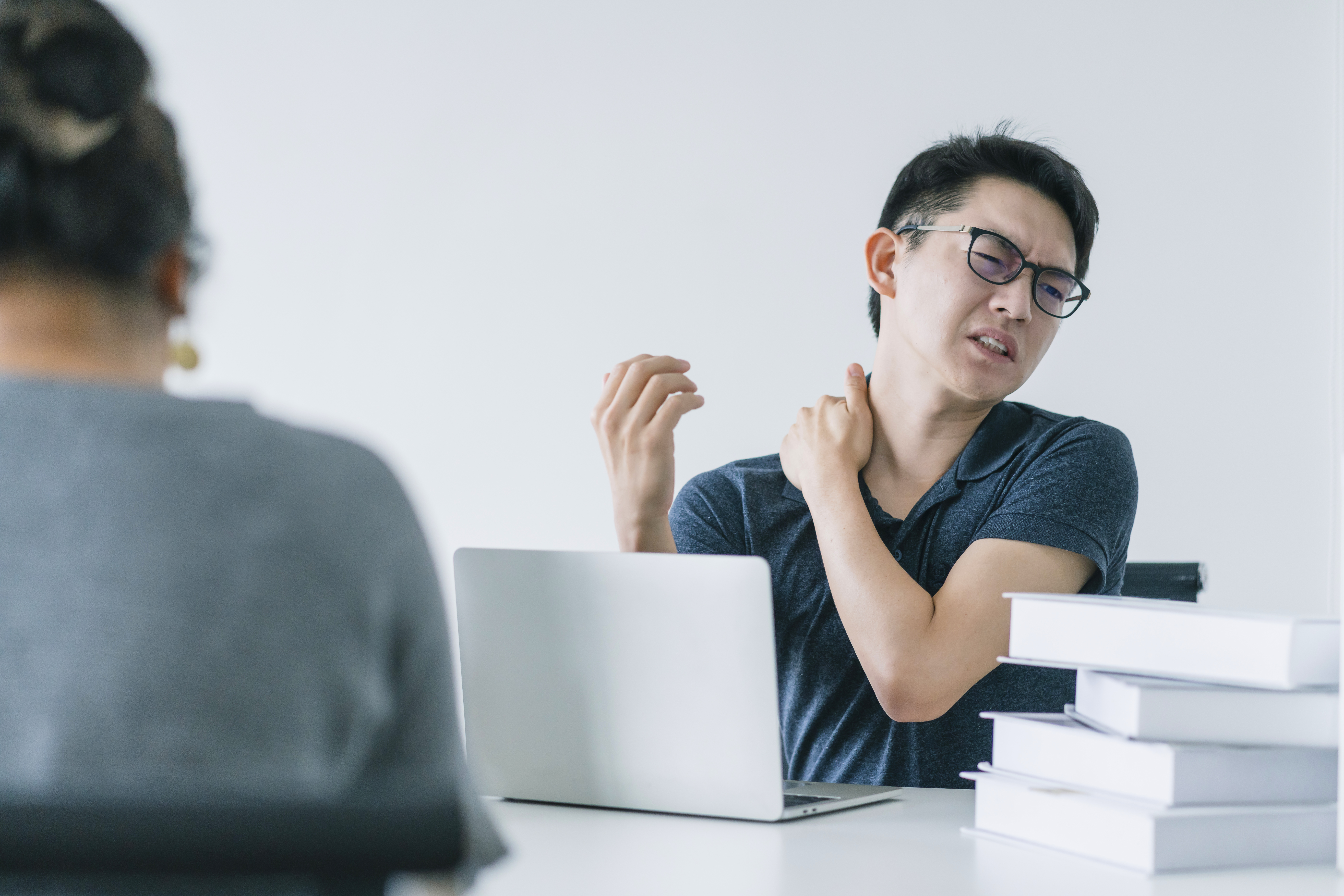 Man with neck strain from desk posture