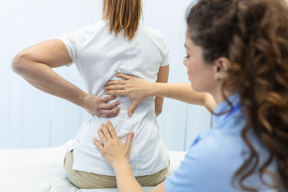 Patient with lower back pain due to spinal stenosis