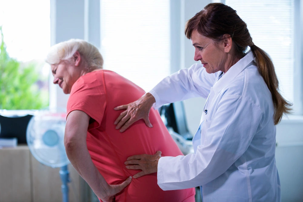 Person experiencing chronic lower back pain from degenerative disc disease