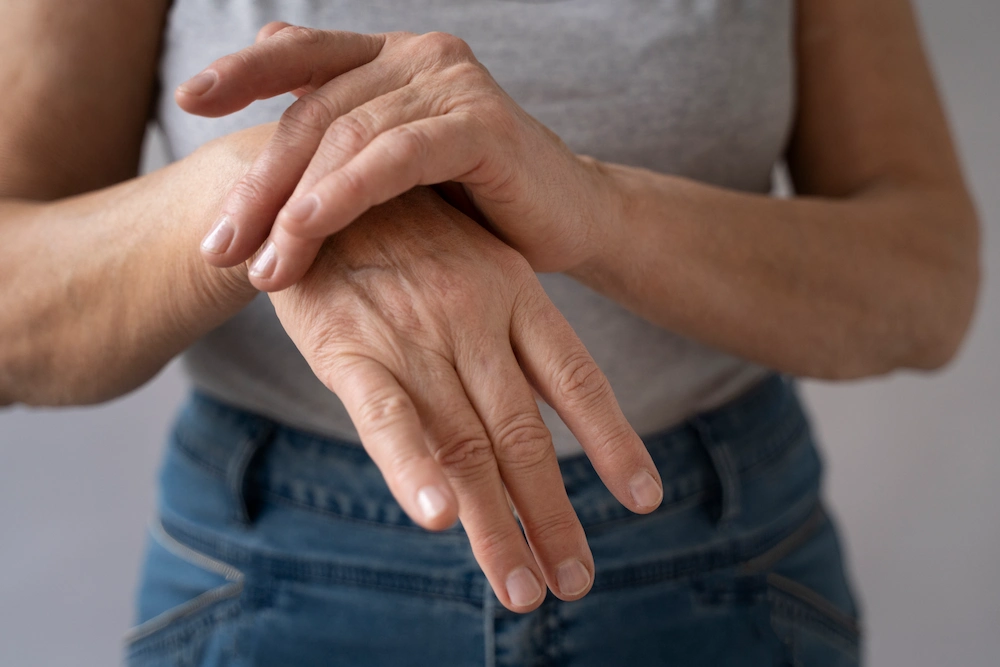 Person holding wrist and arm due to pinched nerve pain