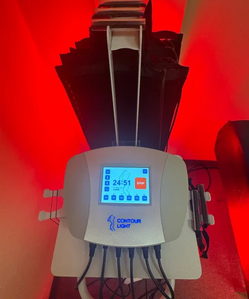 Contour light weight loss machine with red light behind it